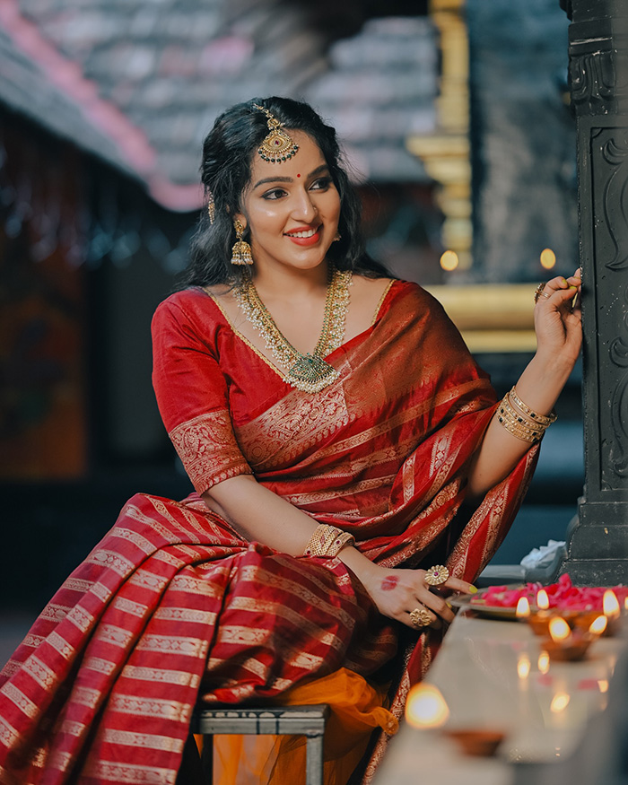 Malavika Menon dazzled in a beautiful red traditional saree, perfectly embodying the festive spirit and elegance that Diwali celebrations are known for.