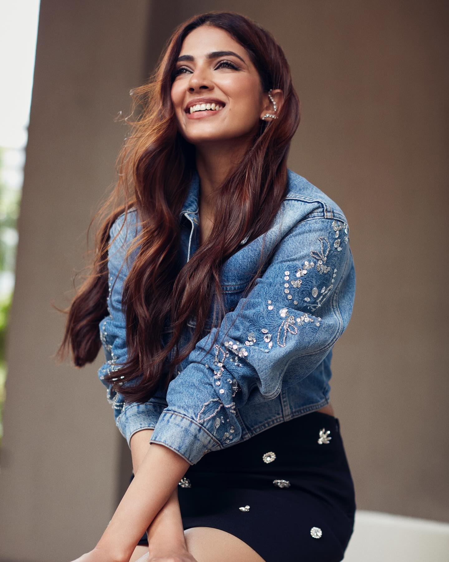Malavika Mohanan stuns in a cropped denim jacket paired with a black, fitted mini-skirt