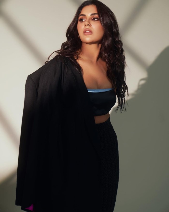 Pairing smooth fabrics with textured skirts or other pieces adds depth to her outfits, creating a balanced look.