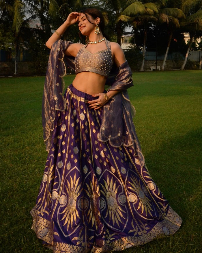 The lehenga features intricate gold and silver embroidery, adding a touch of regality and elegance to her look.