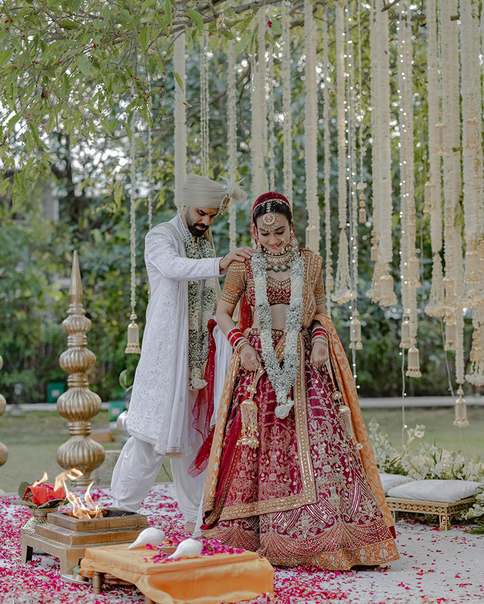 Touching images of Surbhi and Sumit exchanging vows capture the deep love and commitment they share, creating timeless memories of their union.