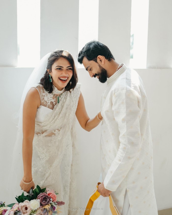 Amala and Jagat wore matching lavender-colored outfits, with Amala in a lehenga and Jagat in a sherwani.