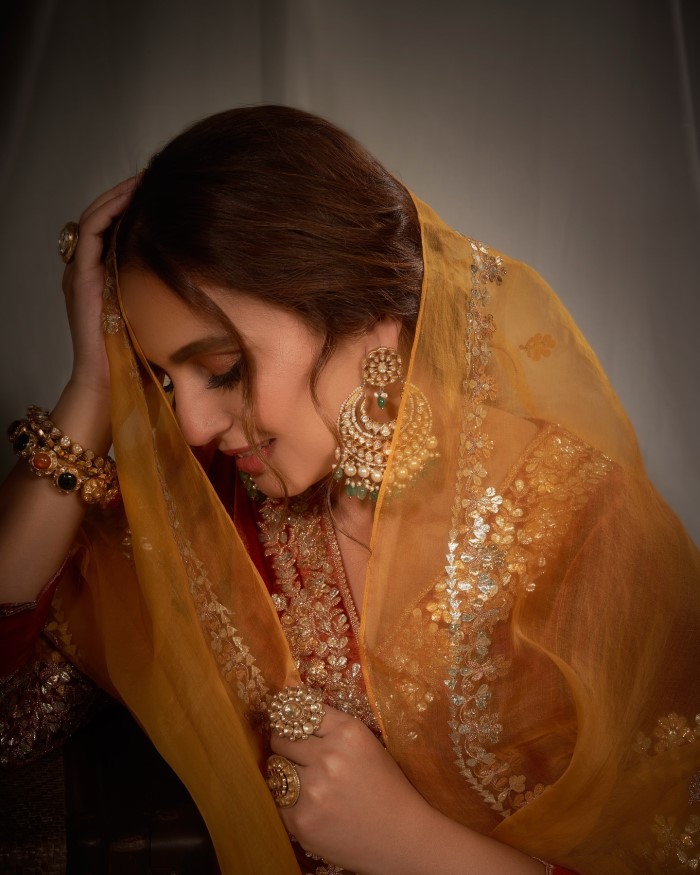 Completing the look, Huma drapes a matching mustard yellow dupatta with gold embroidery and tassels, enhancing the traditional charm of her outfit.