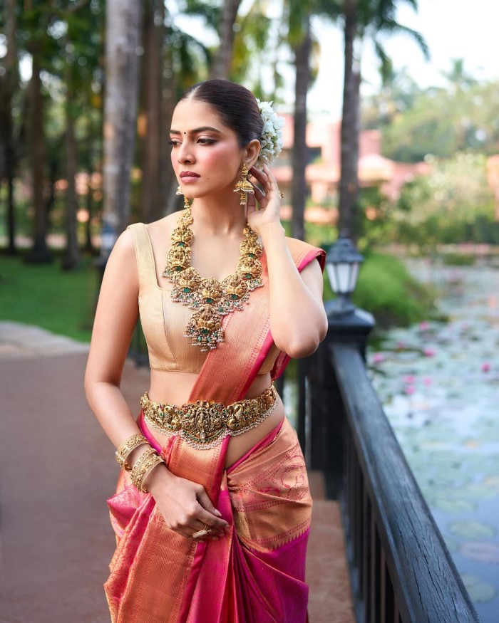 Malavika Mohanan dazzles in a rich and vibrant Pattu saree, known for its luxurious silk and intricate craftsmanship, showcasing traditional South Indian elegance.