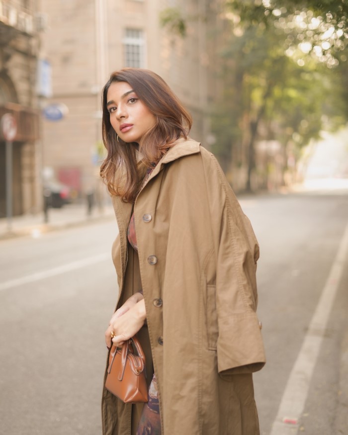 By keeping accessories minimal, Natasha allows the vibrant floral pattern and unique design of her dress to take center stage, showcasing her natural beauty and confidence.