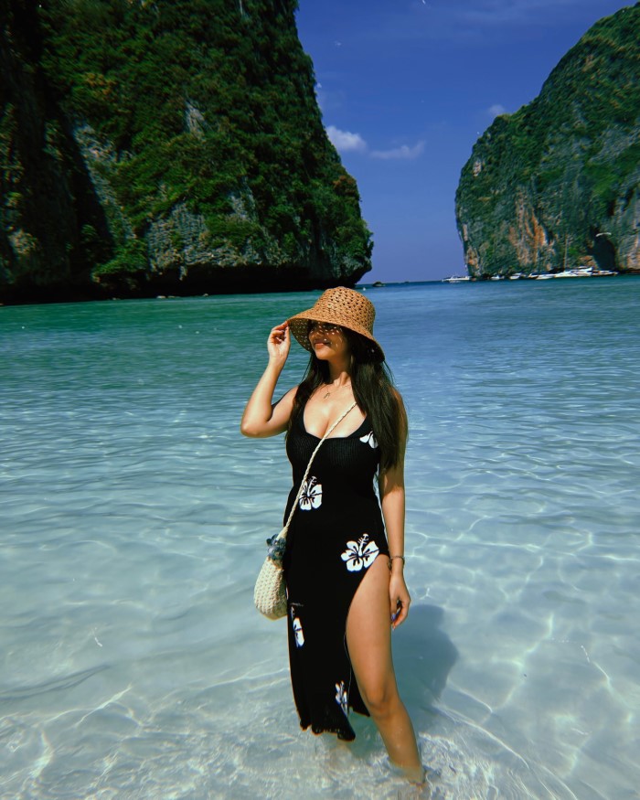 She poses for a candid shoot, capturing natural and spontaneous moments against the stunning backdrop of Maya Bay.