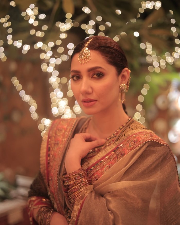 She pairs the kurta with a red silk salwar, adding a vibrant contrast that enhances the overall richness of the outfit.