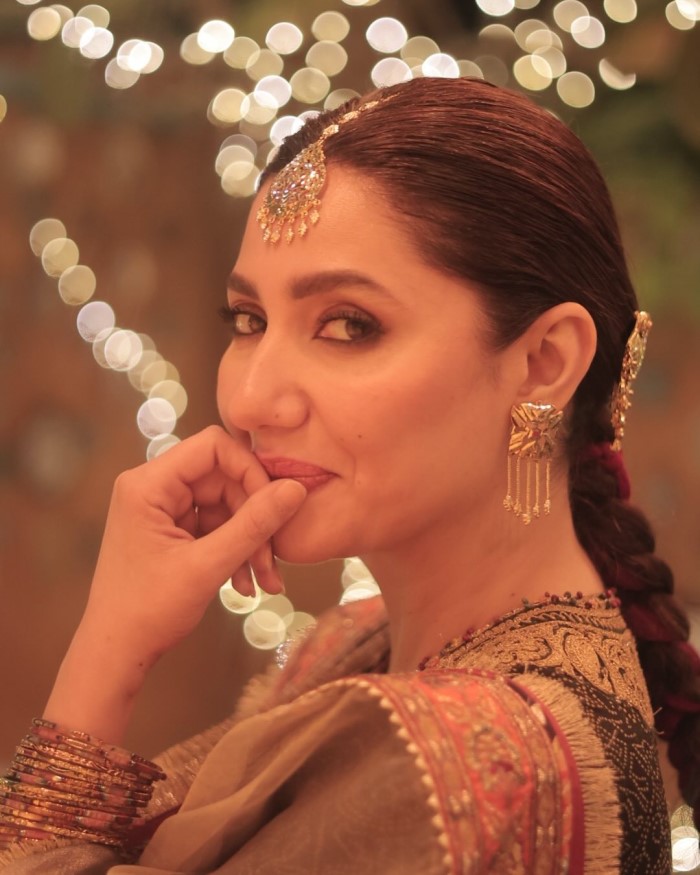 The look is completed with a beige dupatta adorned with beautiful embroidery, adding an extra layer of elegance to her ensemble.