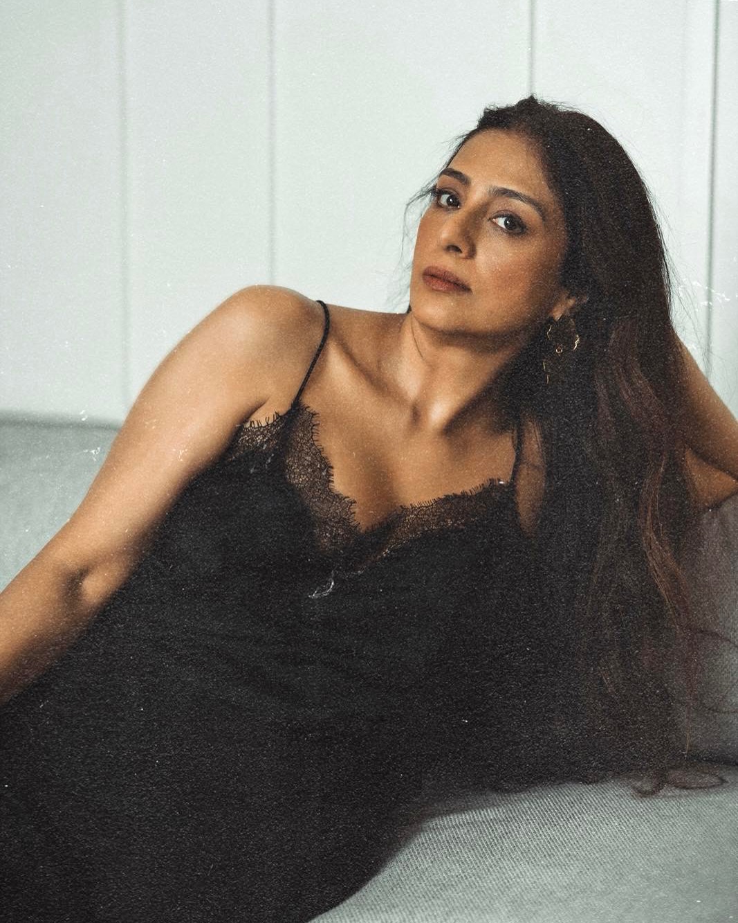 Tabu's choice of a black slip dress with lace detailing exudes effortless sophistication.