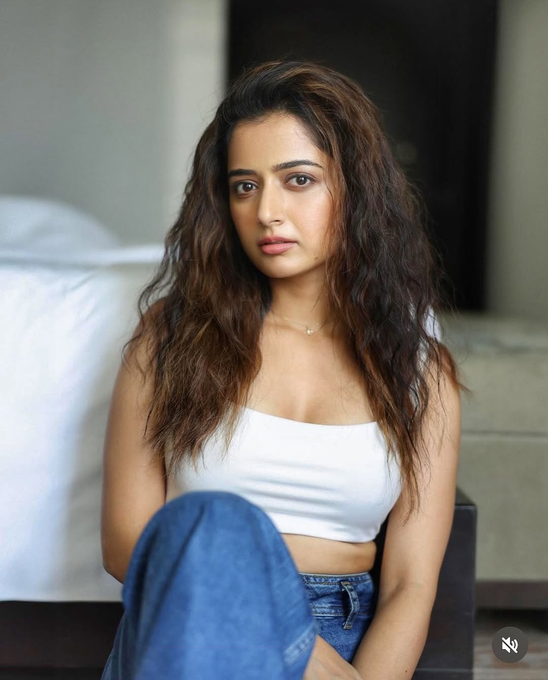 Ashika Ranganath's Stunning Photoshoot In White Crop Top And Blue Denim Jeans