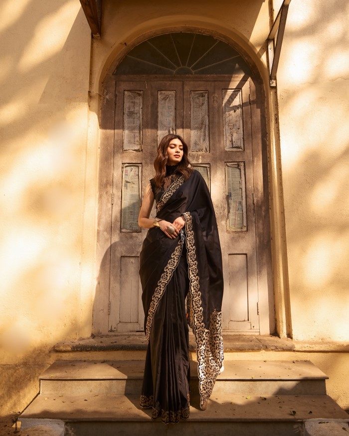 Diana's poised and confident presence in the outdoor setting, with a blurred, neutral-toned background, emphasizes her natural beauty and the elegance of her ensemble.