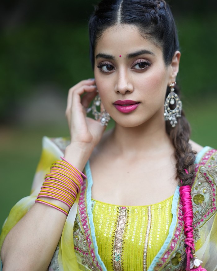 Janhvi accessorized with pink and yellow bangles, silver earrings, and Punjabi juttis, completing her festive look.