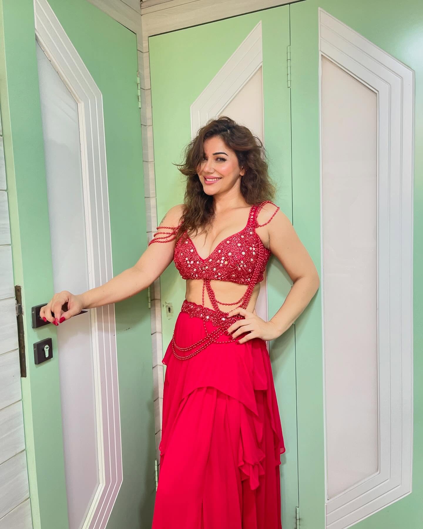 Kangna Sharma is seen wearing a striking red outfit.