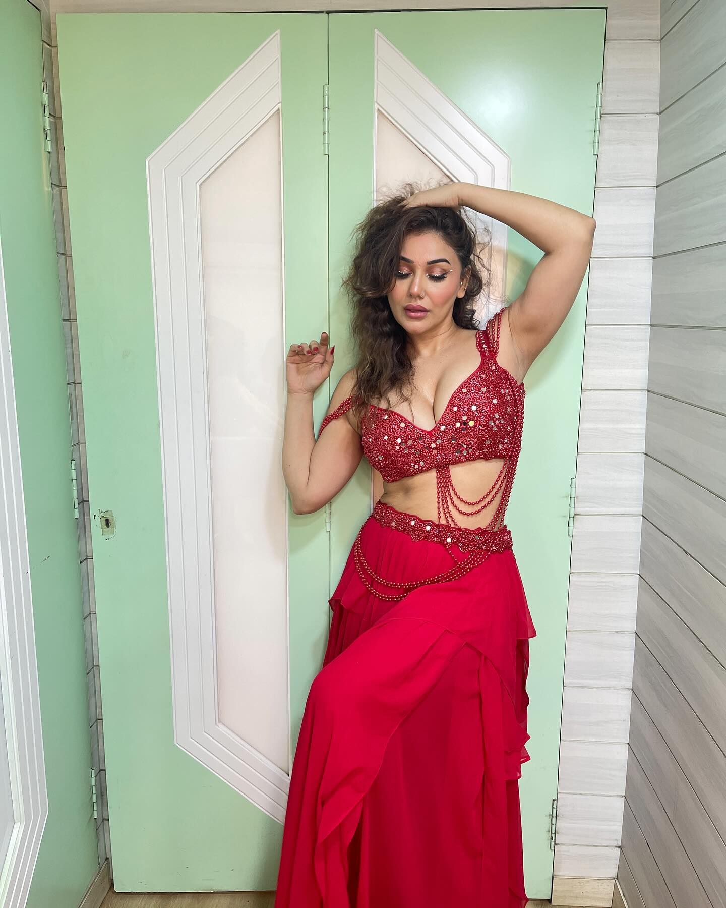 Kangna Sharma is seen wearing a striking red outfit.