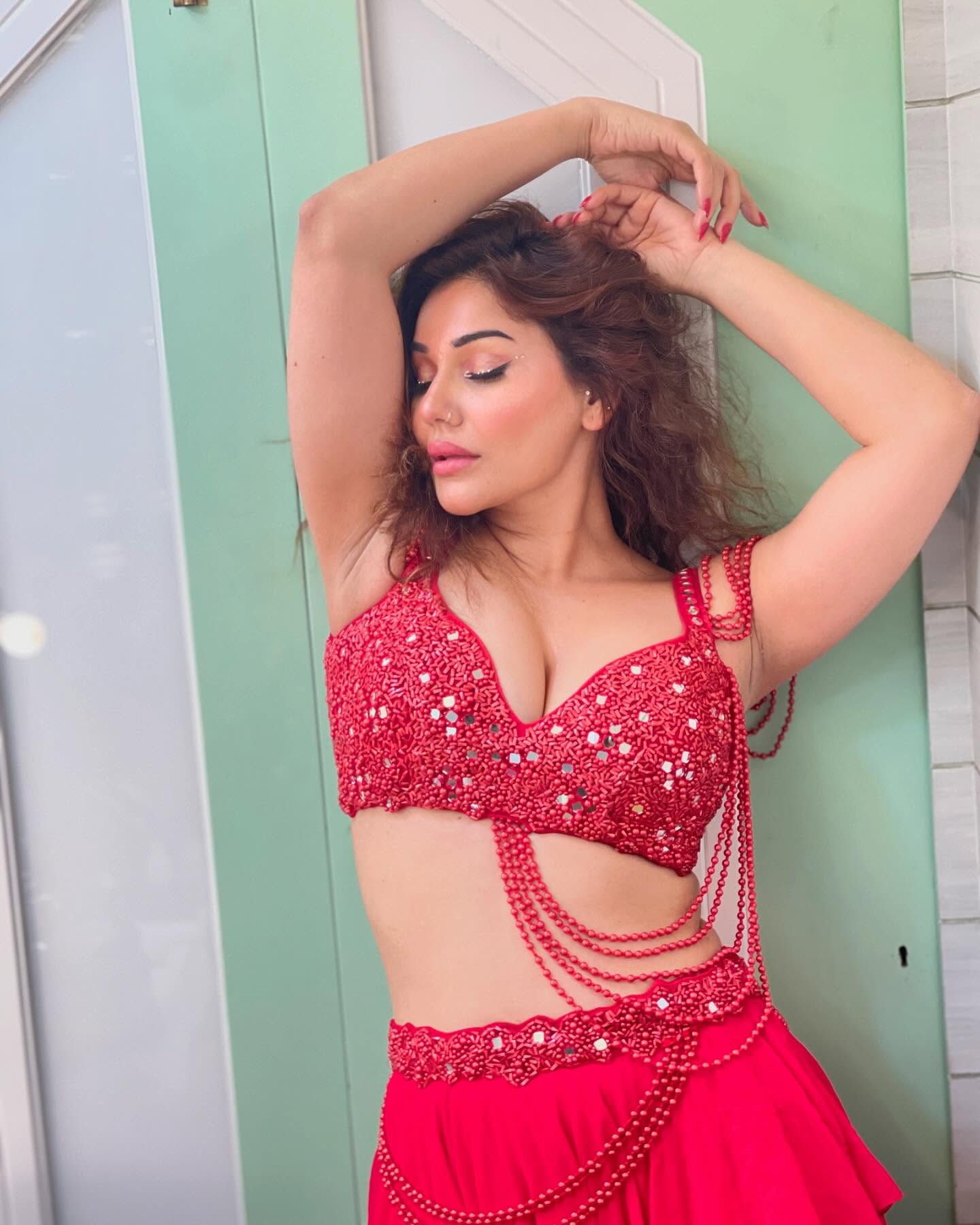 Kangna Sharma is seen wearing a striking red outfit.