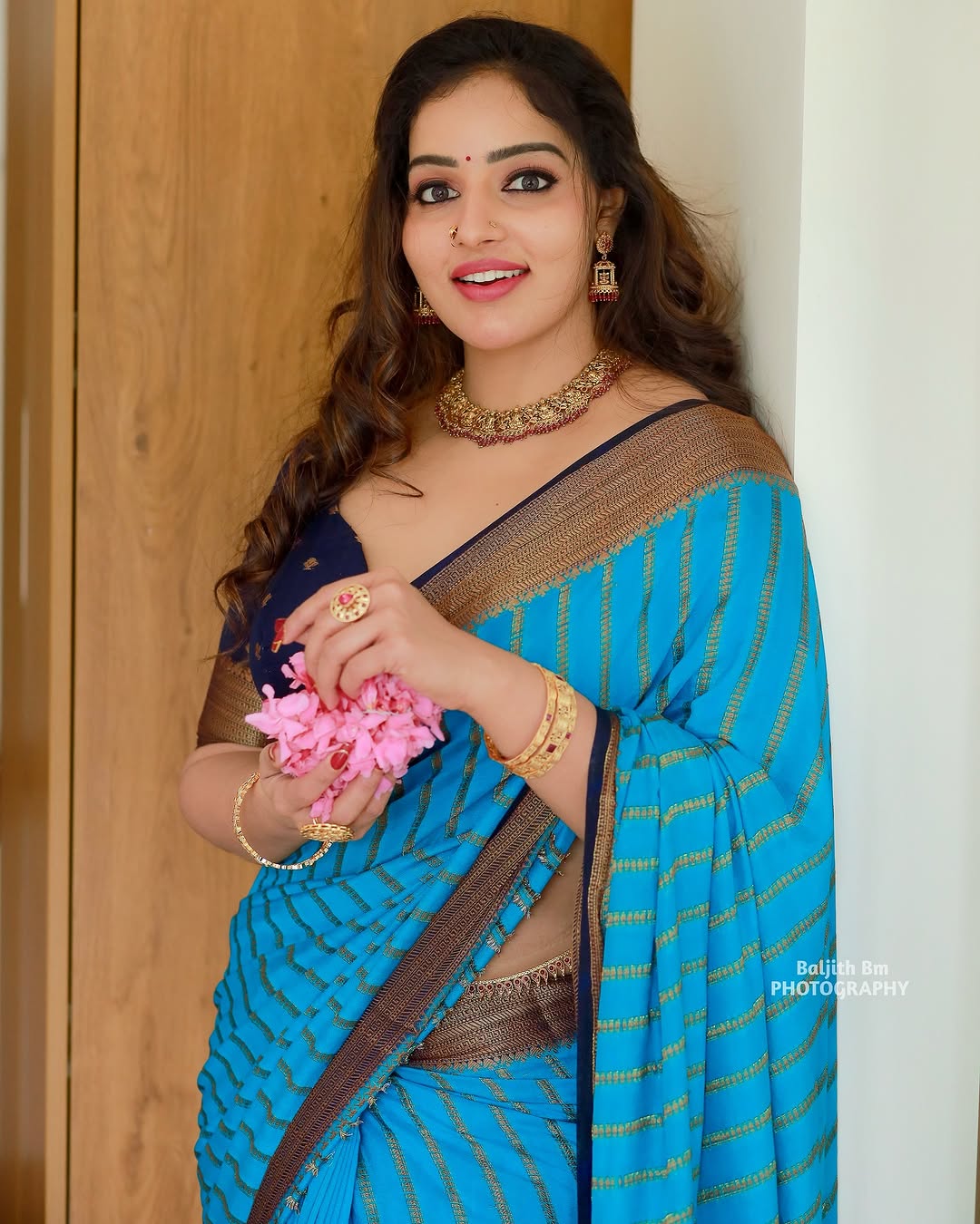 Malavika Menon exudes grace in a stunning turquoise-blue saree with golden accents