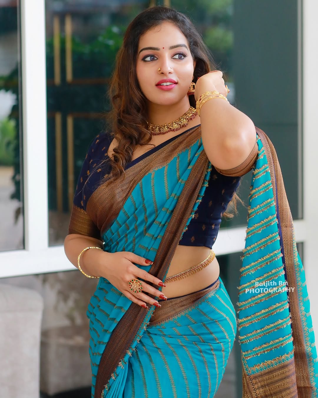 Malavika Menon exudes grace in a stunning turquoise-blue saree with golden accents