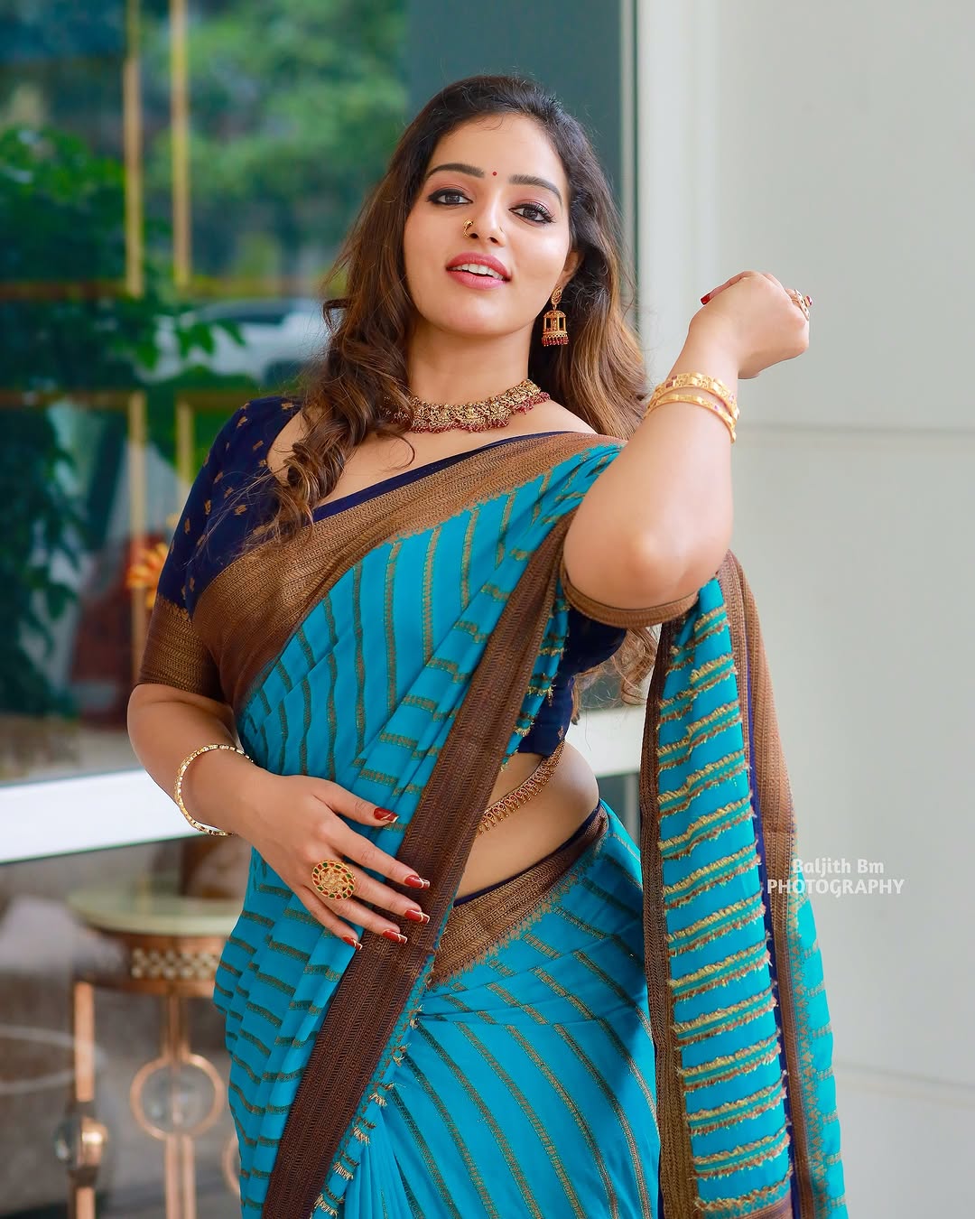 Malavika Menon exudes grace in a stunning turquoise-blue saree with golden accents
