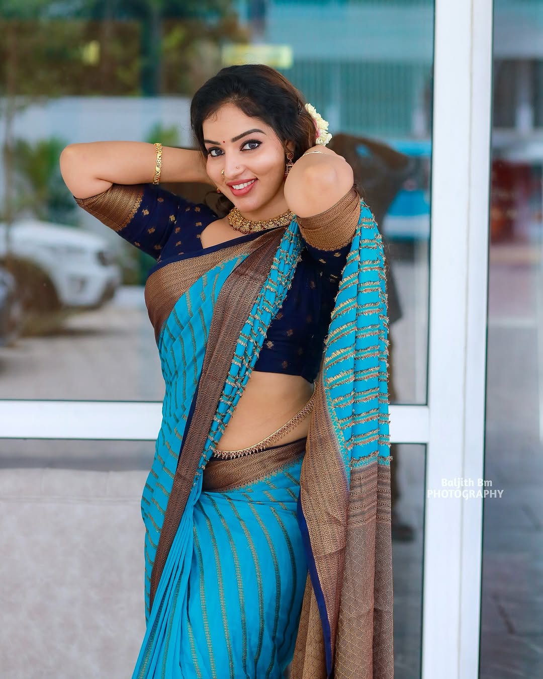 Malavika Menon exudes grace in a stunning turquoise-blue saree with golden accents