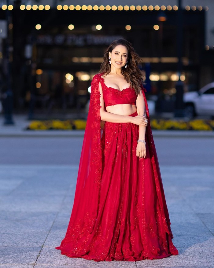 Her graceful and confident demeanor perfectly complemented the vibrant red lehenga, making her the center of attention.