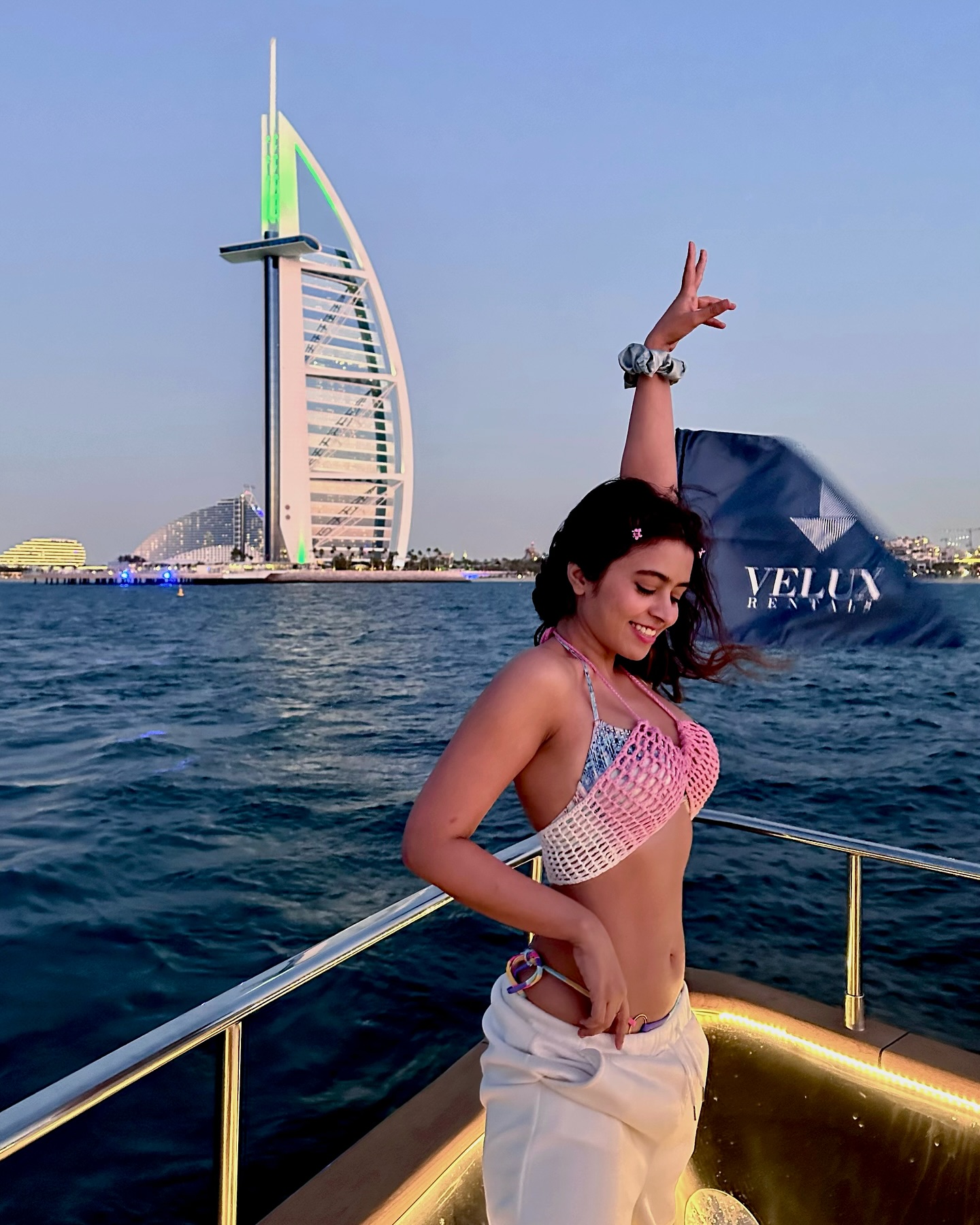 Shobhita Rana stuns in a chic pink and white crochet bikini top, paired with trendy white joggers, perfect for a breezy yacht day in Dubai.