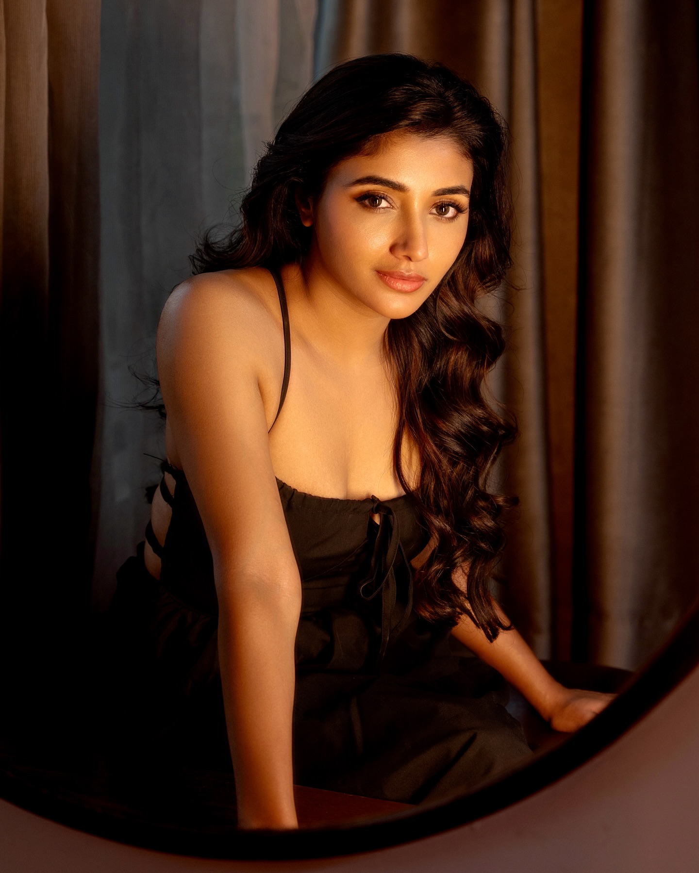 Mirnaa stuns in a chic black sleeveless, strappy top paired with wide-legged pants