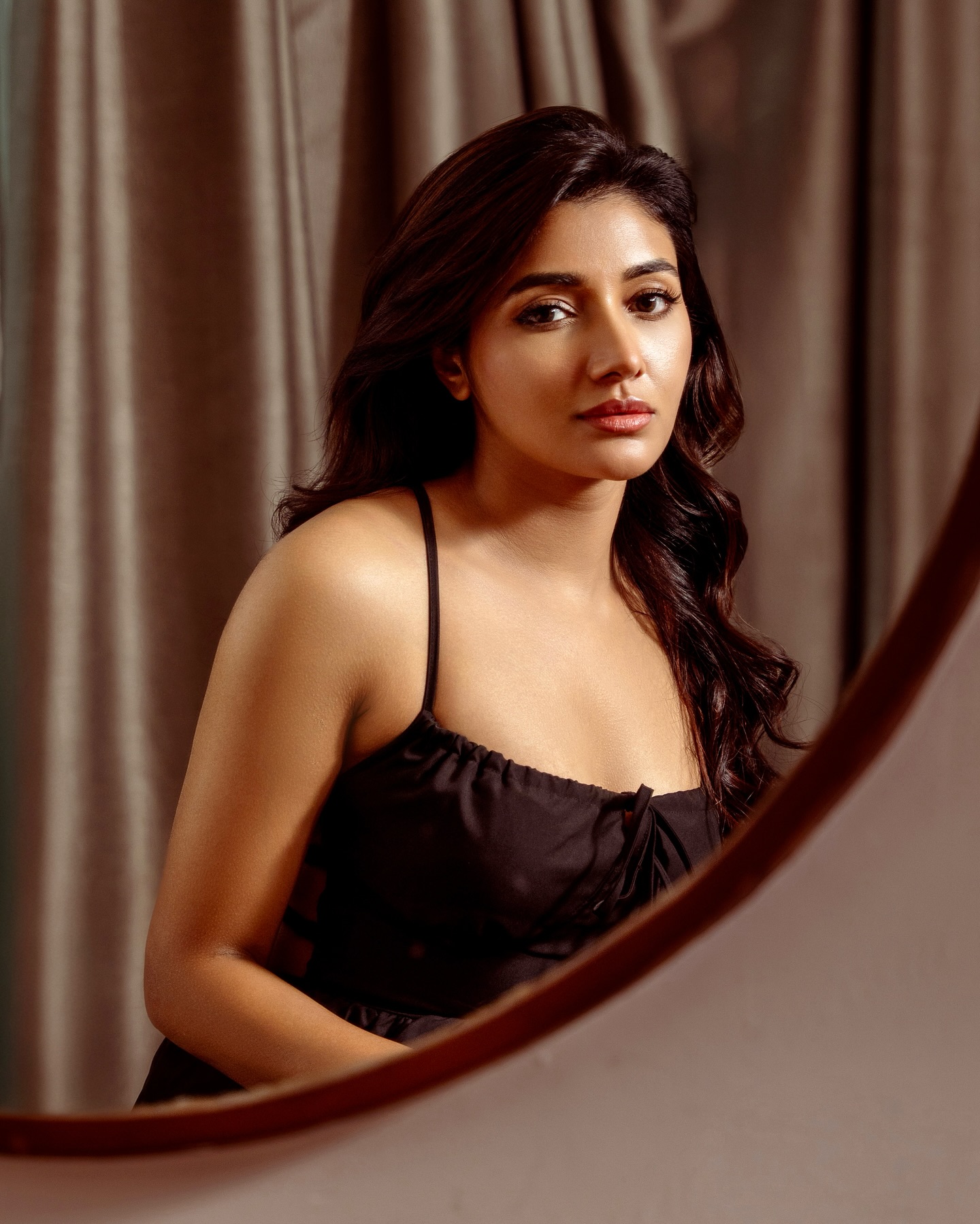 Mirnaa stuns in a chic black sleeveless, strappy top paired with wide-legged pants