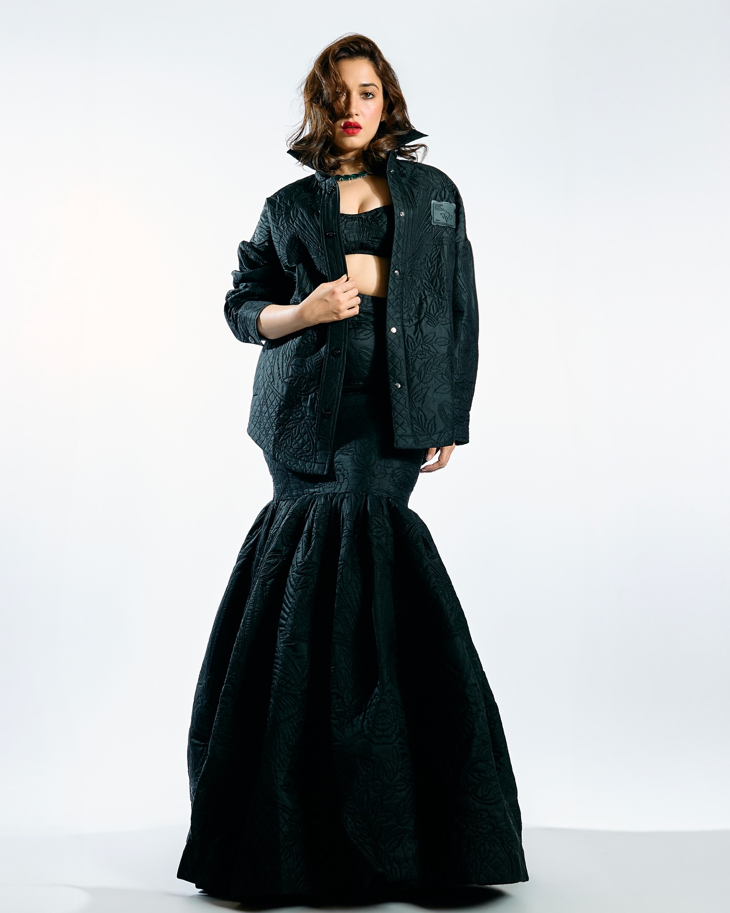 Tamannaah stuns in an all-black, quilted, textured outfit with an oversized jacket and a voluminous skirt.