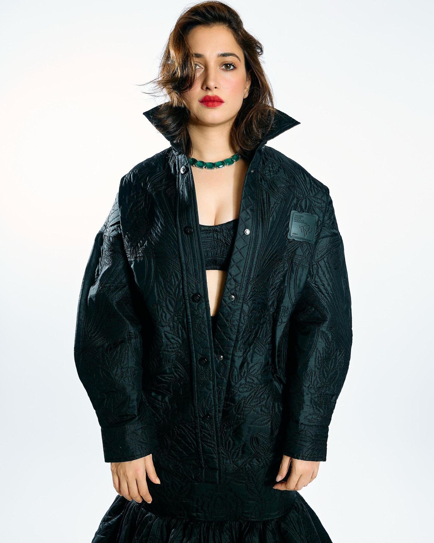 Tamannaah stuns in an all-black, quilted, textured outfit with an oversized jacket and a voluminous skirt.