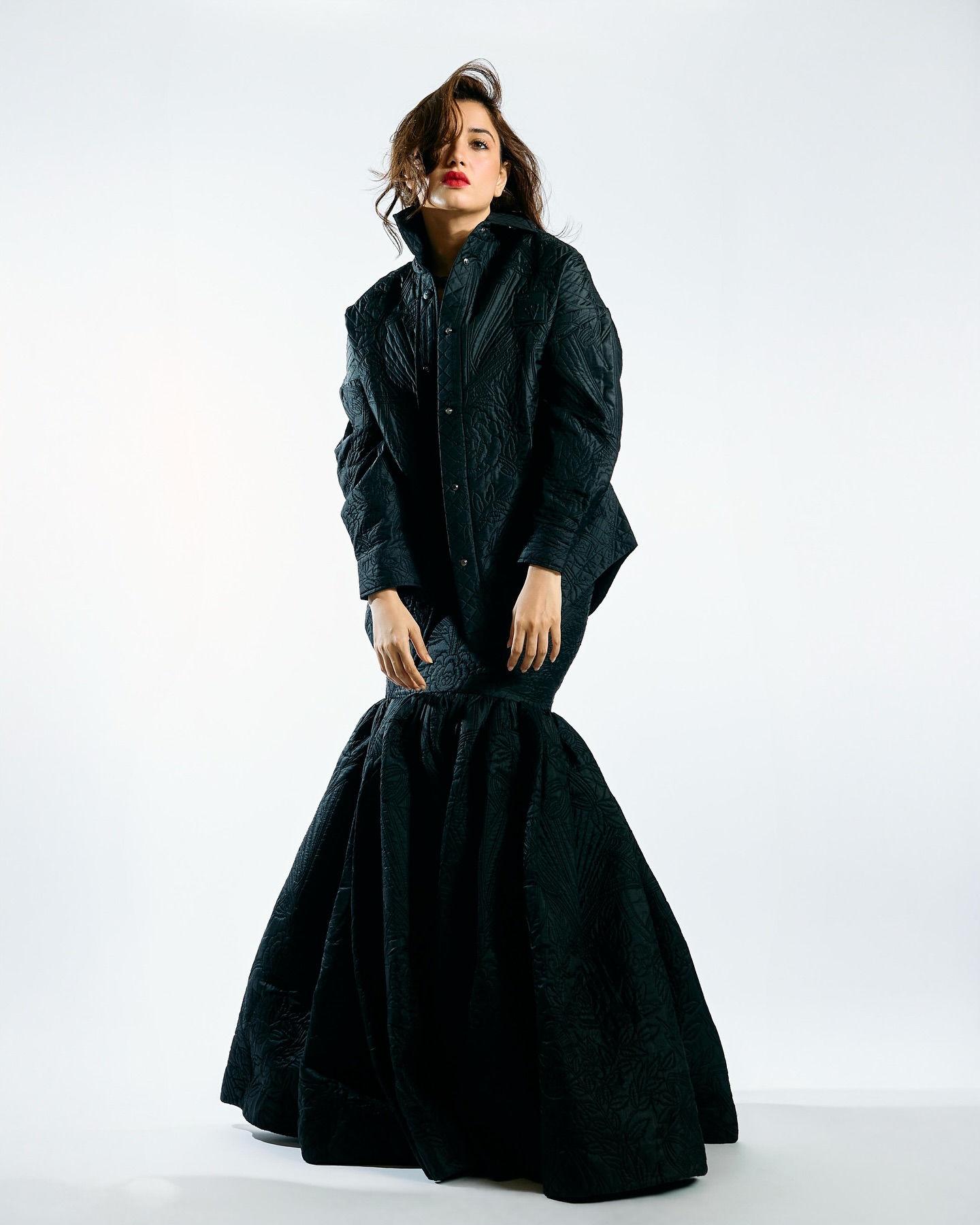 Tamannaah stuns in an all-black, quilted, textured outfit with an oversized jacket and a voluminous skirt.