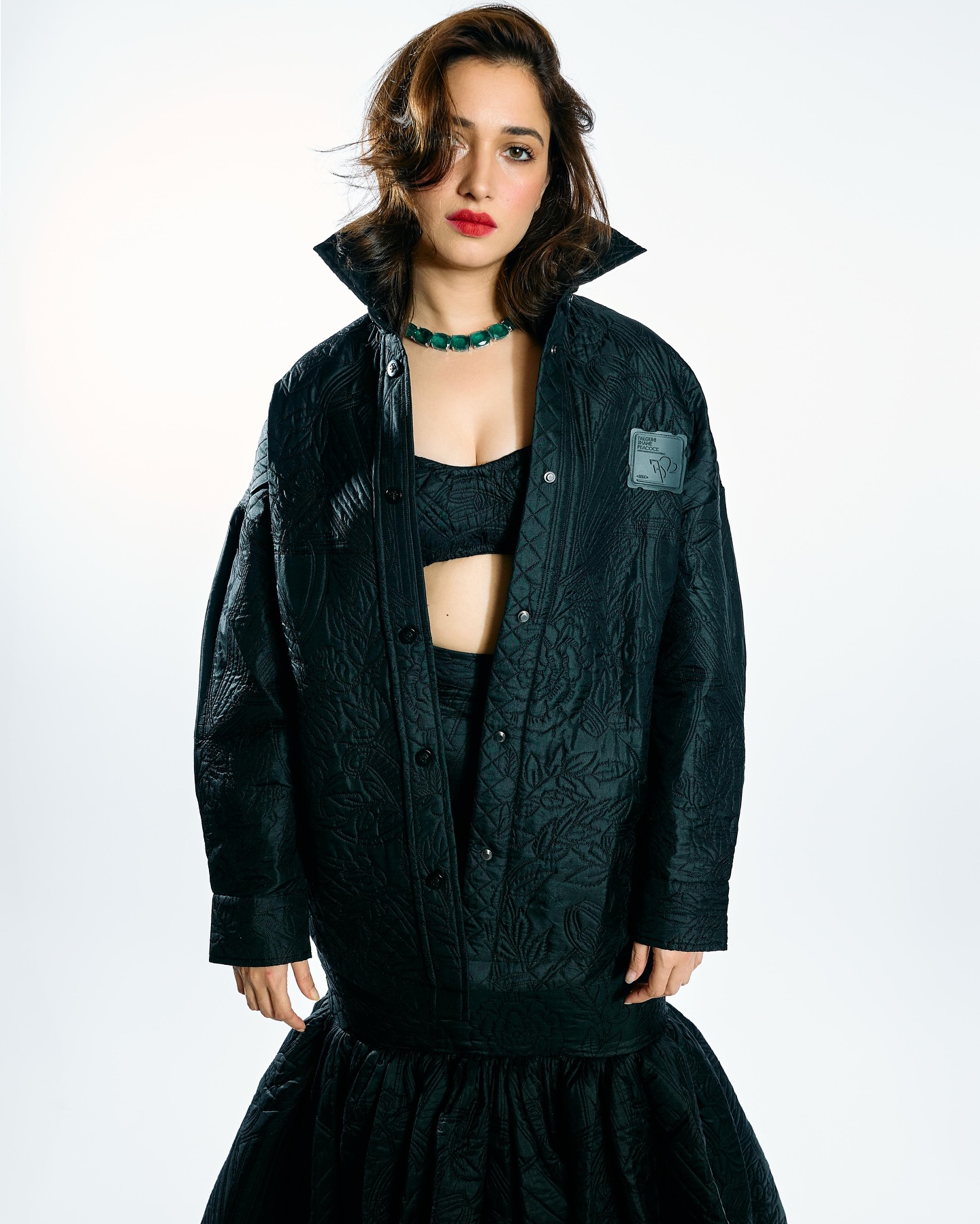 Tamannaah stuns in an all-black, quilted, textured outfit with an oversized jacket and a voluminous skirt.