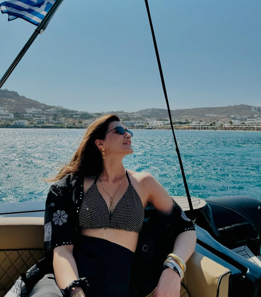 For one of her beachy outings, Kriti, a self-confessed water baby, paired her printed blue bikini top with a matching high waist figure-hugging solid blue skirt with a slit.