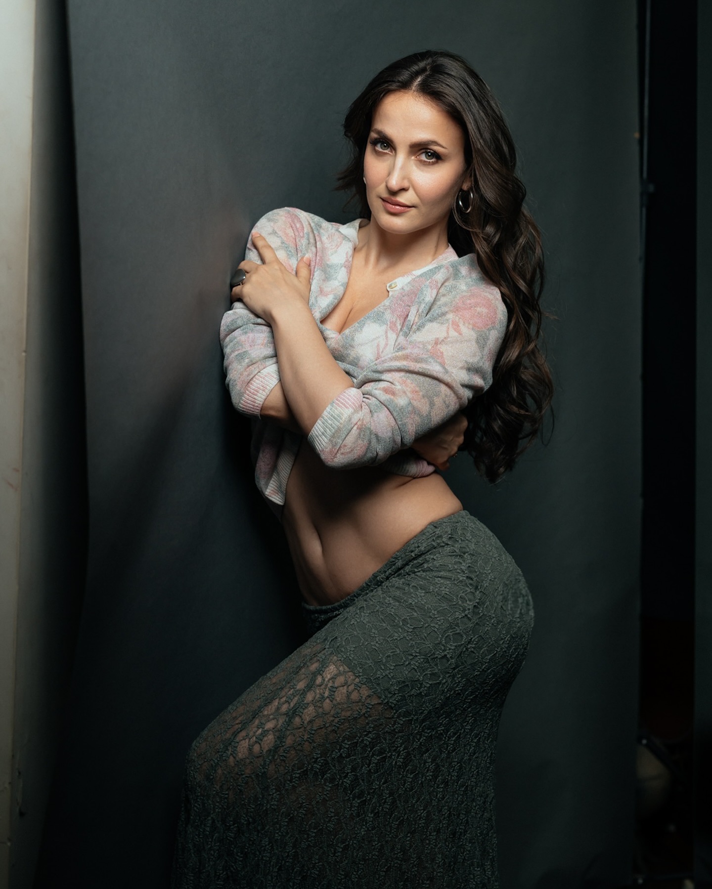 Elli Avram stuns in a floral-patterned cardigan paired with a green skirt.