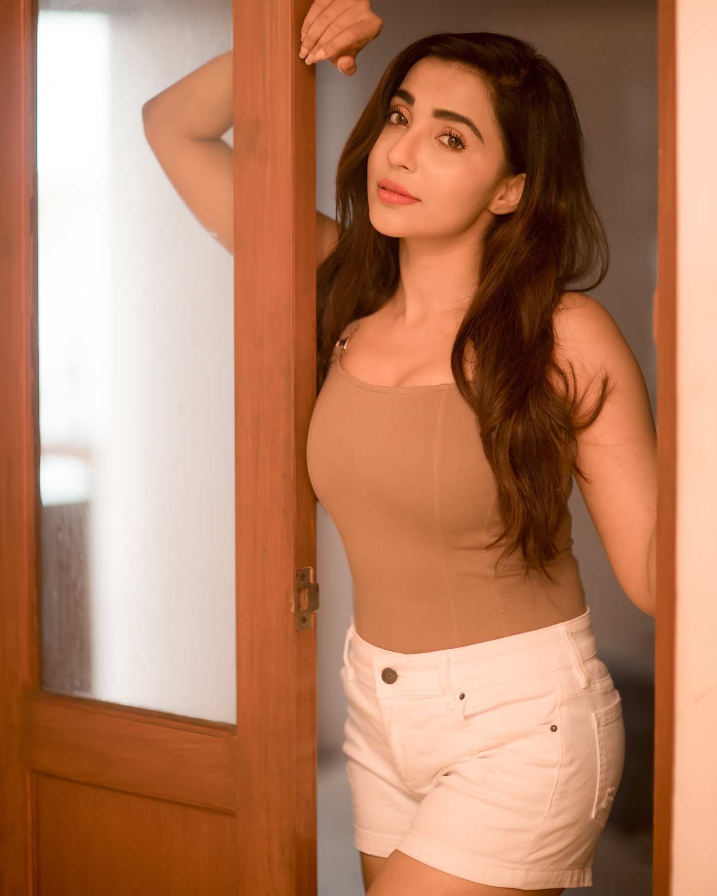 Parvati Nair stuns in a fitted, sleeveless beige top that accentuates her upper body.