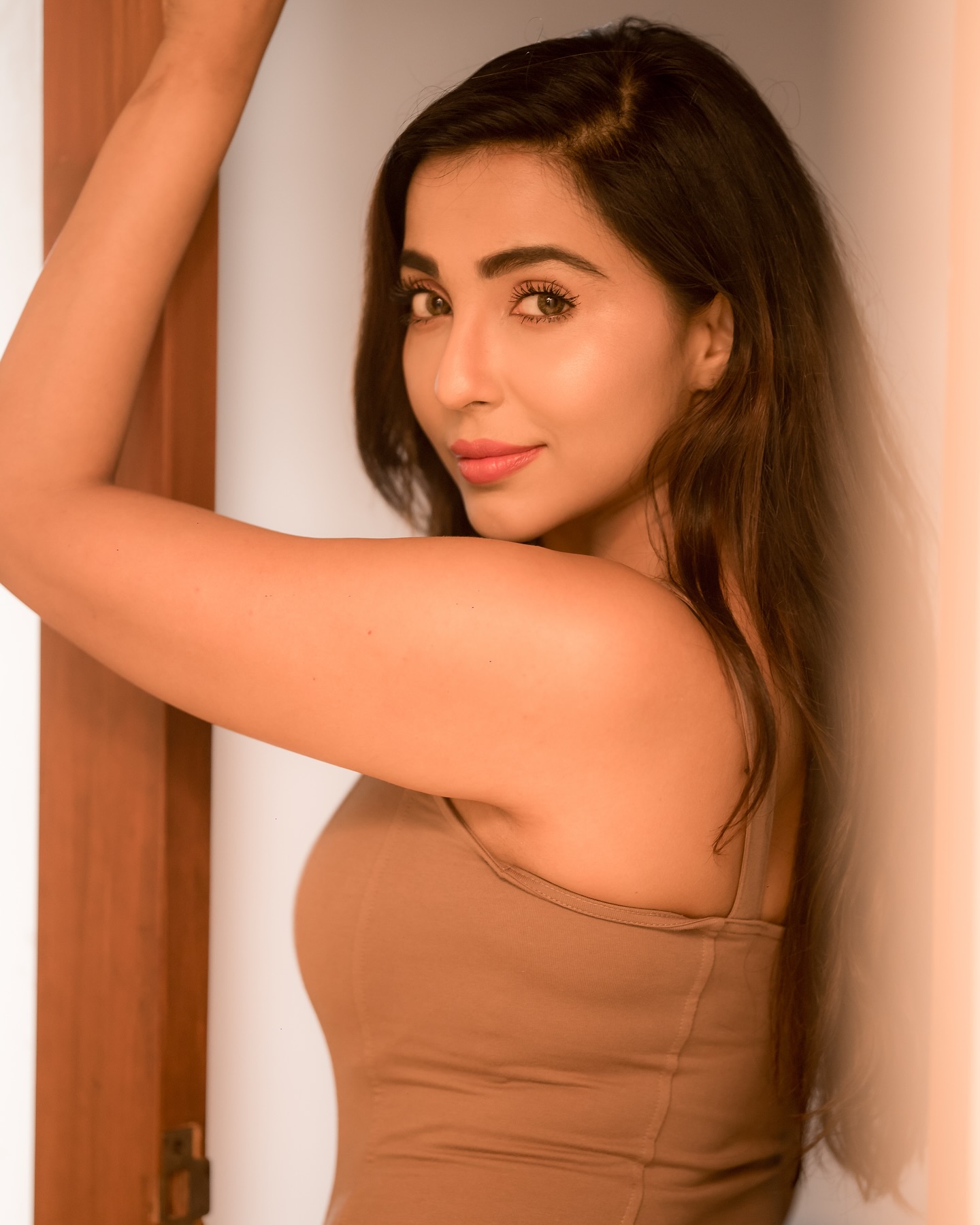 Parvati Nair stuns in a fitted, sleeveless beige top that accentuates her upper body.