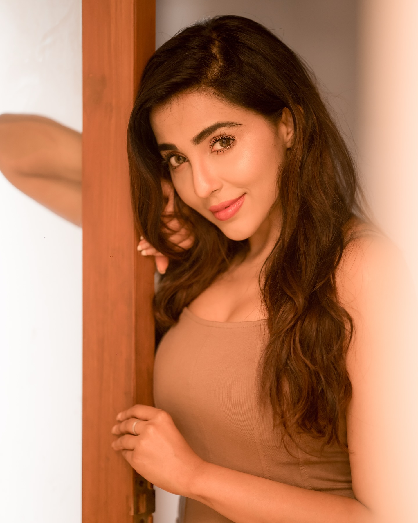 Parvati Nair stuns in a fitted, sleeveless beige top that accentuates her upper body.