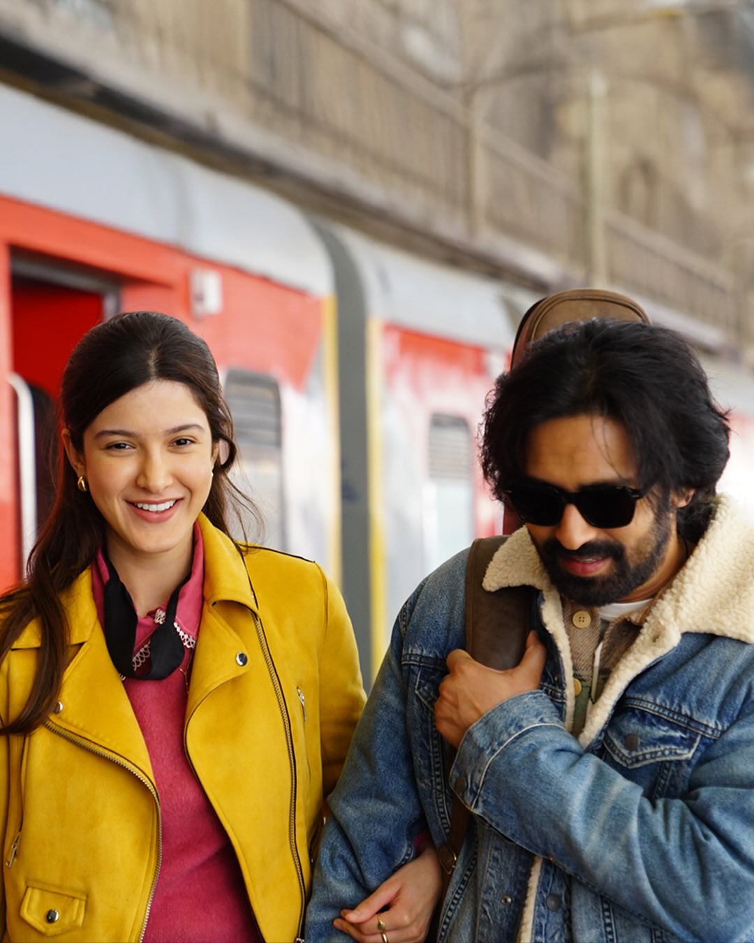 A cinematic still featuring Vikrant Massey and Shanaya Kapoor at a railway station, evoking nostalgia and quiet romance