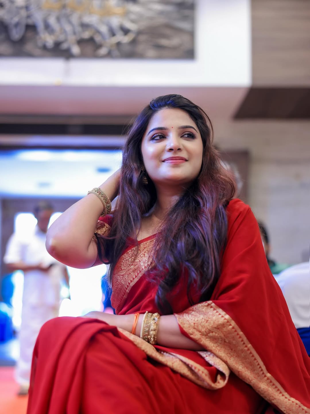 Aathmika stuns in red, redefining power dressing–one elegant drape and confident glance at a time