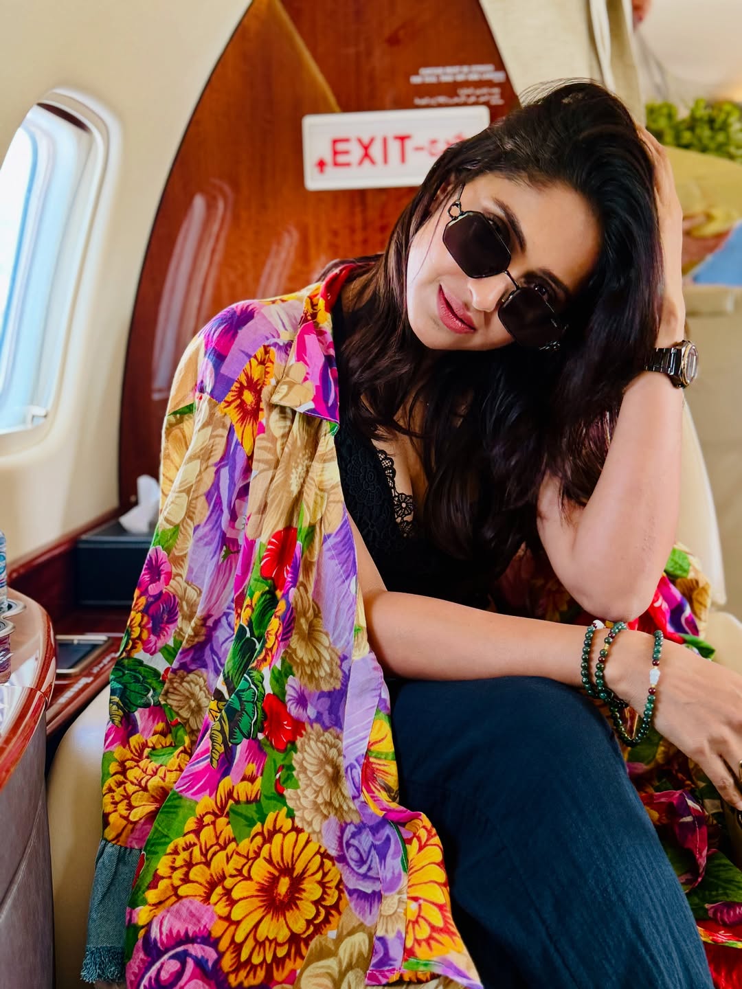 Aysha’s ensemble is a bold burst of color and confidence–floral prints, chic sunglasses, and just the right attitude to elevate any journey