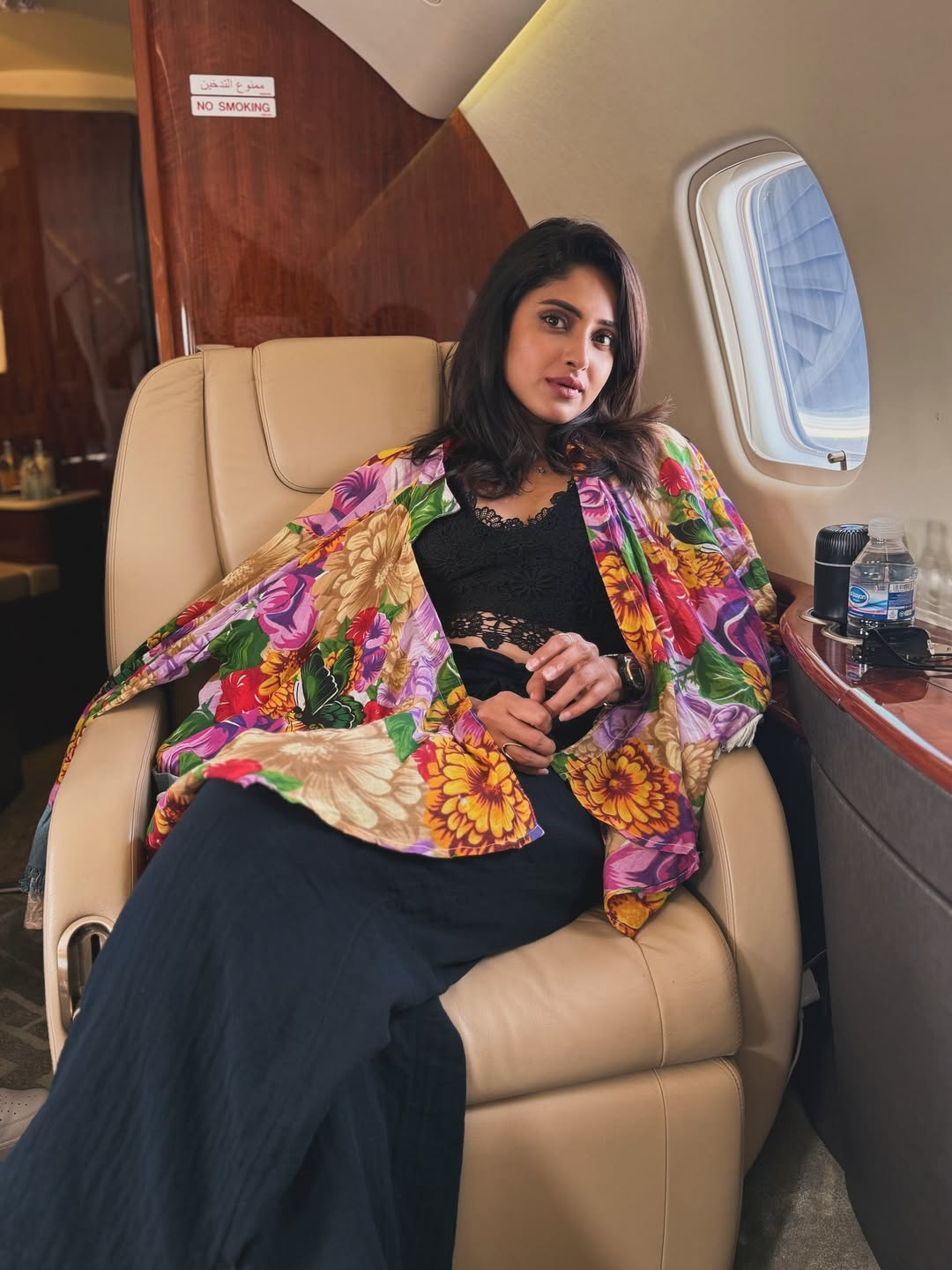 Aysha redefines in-flight fashion–floral finesse, poised charm, and a window seat that doubles as her personal runway