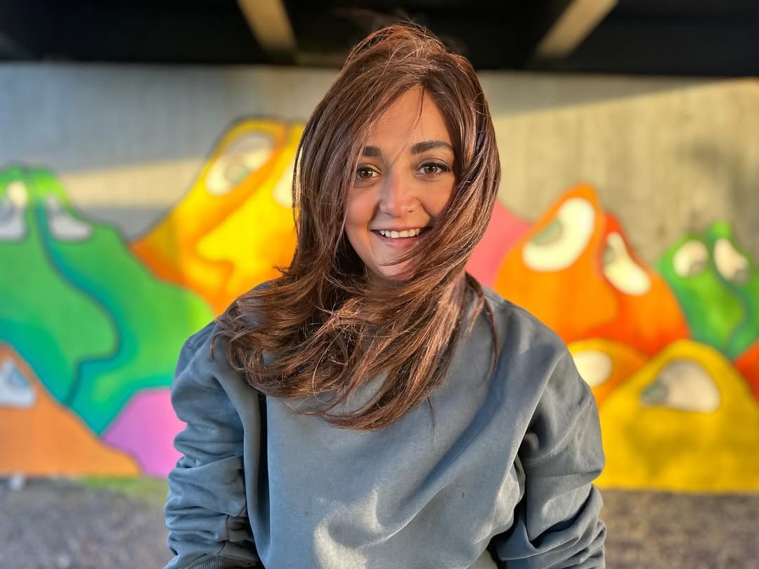 Monali’s smile is brighter than the graffiti-and that’s saying something when your backdrop looks like a Skittles explosion