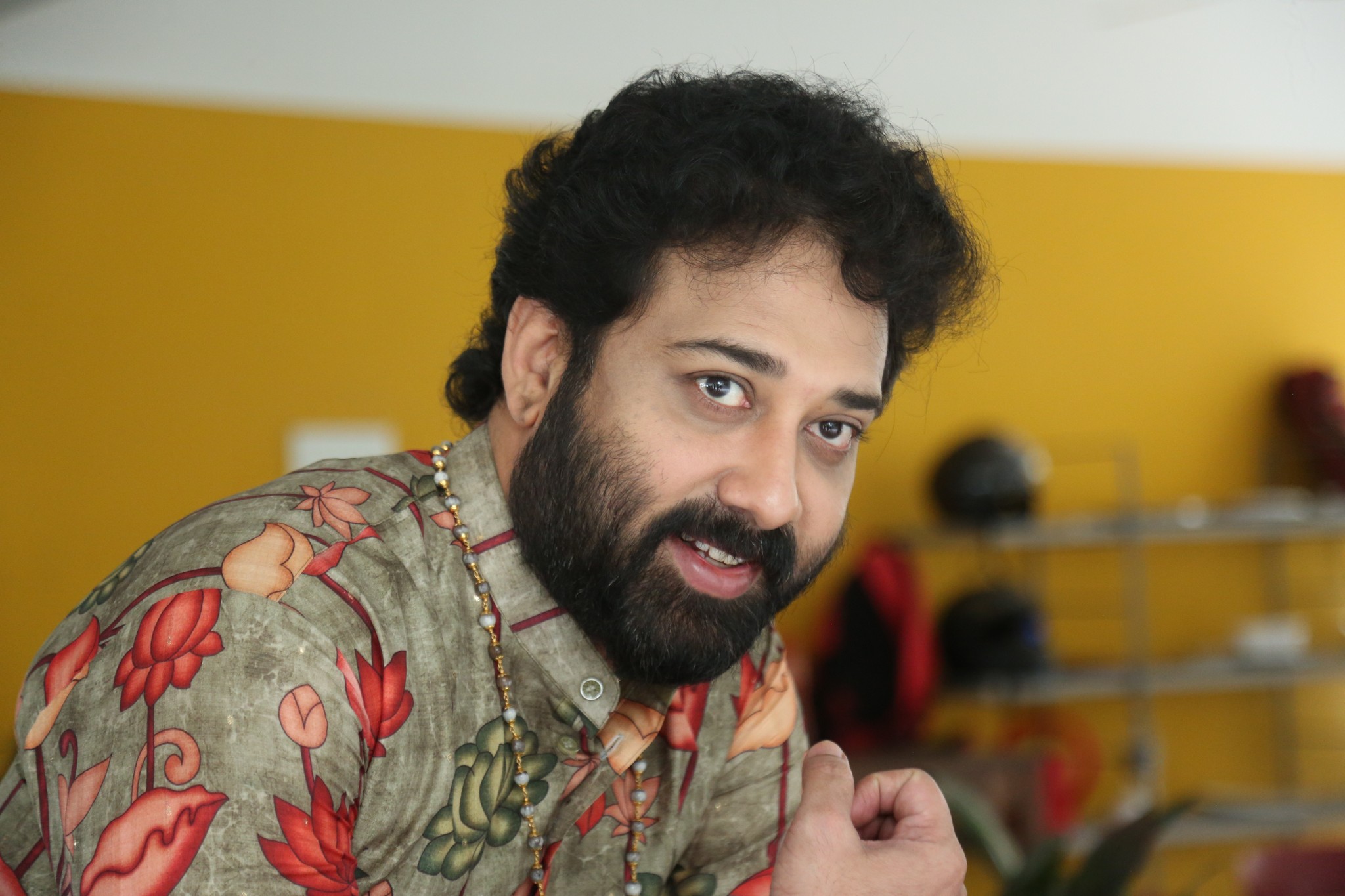 Siva Balaji sporting florals like a pro–serving tropical vibes with a grin that could outshine the sun