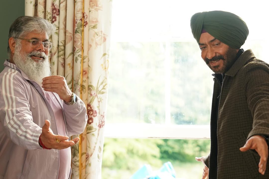 Ajay Devgn and director Vijay Kumar Arora are captured in a candid exchange, collaborating closely to fine-tune a pivotal scene