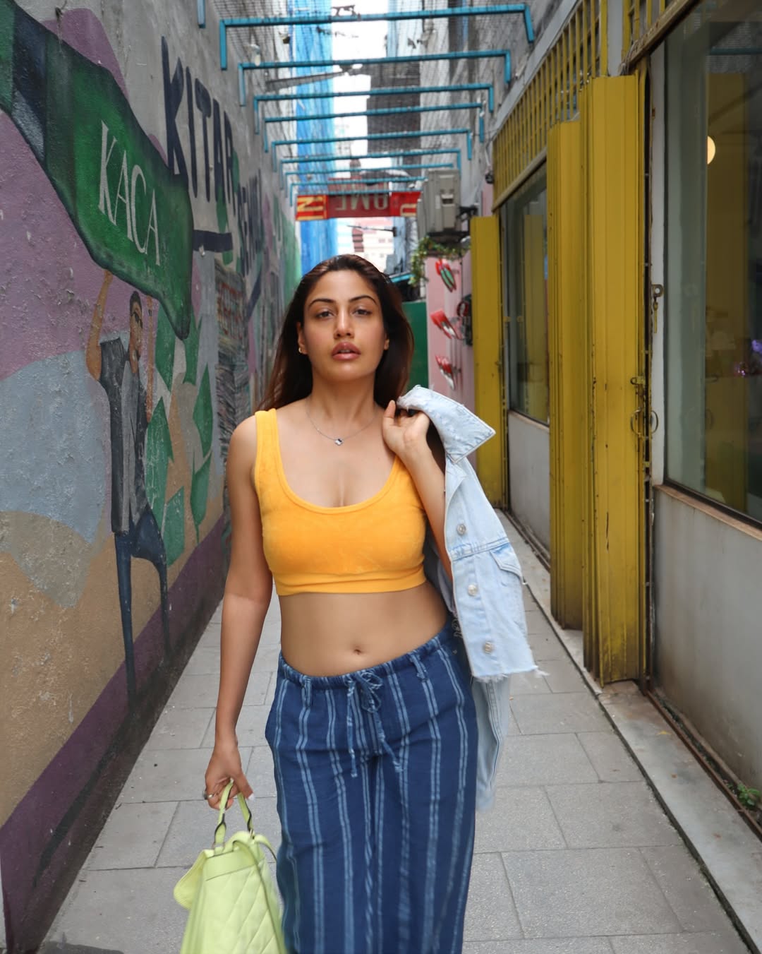 Effortlessly stylish in a yellow crop top and striped pants, Surbhi Chandna transforms everyday streetwear into a standout fashion statement
