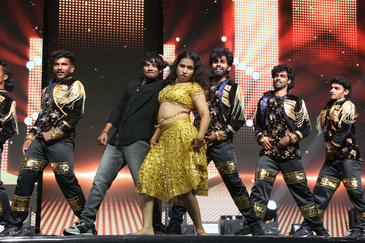 A vibrant dance performance lights up the stage, setting the tone for the high-energy pre-release celebration.