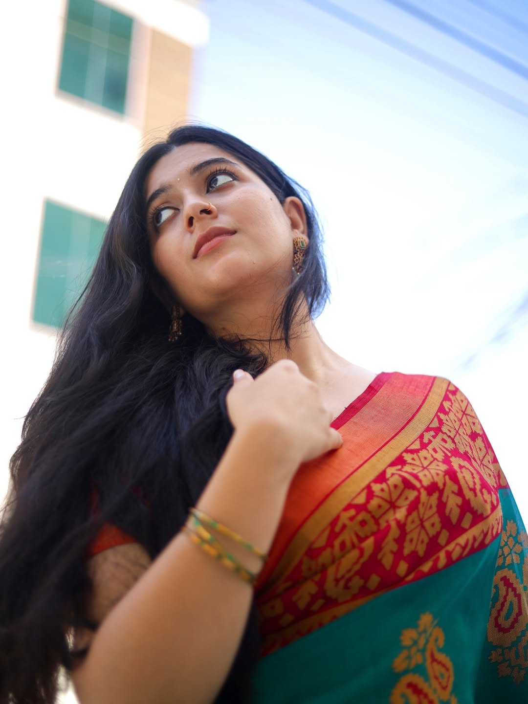 Kanduri Sudha exudes timeless elegance with a vibrant, traditional saree–proof that style and grace are best served with a splash of humor and a confident smile!