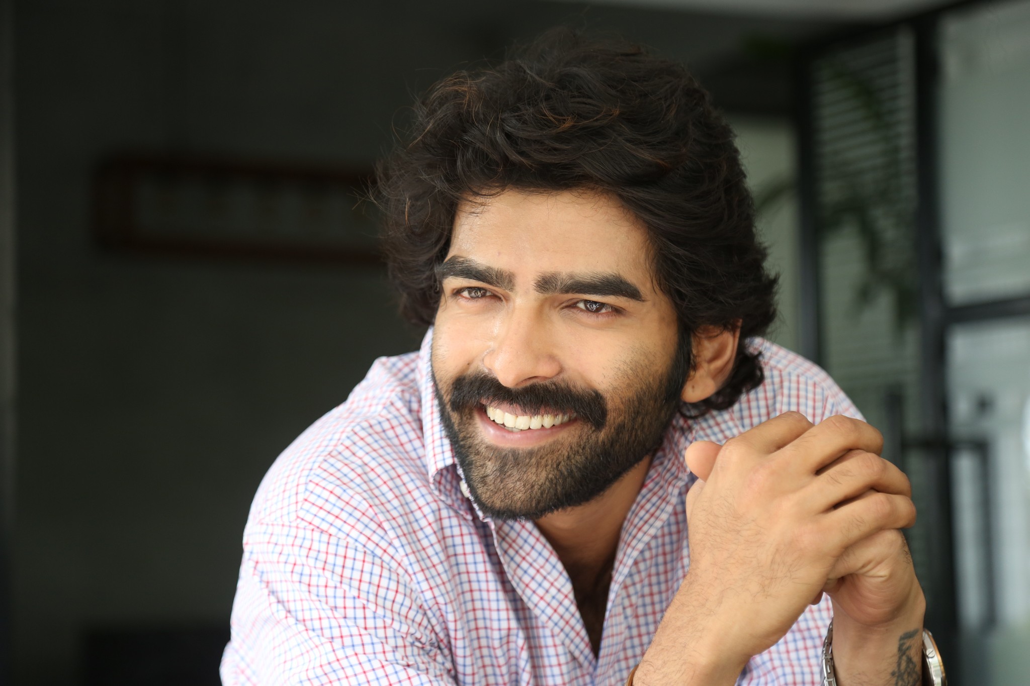 Manoj Chandra nails the sharp-dressed look with a confident grin, proving that a splash of humor is the ultimate accessory for timeless professional appeal.