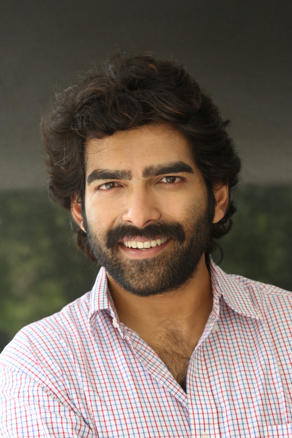 Manoj Chandra proves that classic confidence paired with a standout shirt is a look that never ages–his grin alone could close any deal!