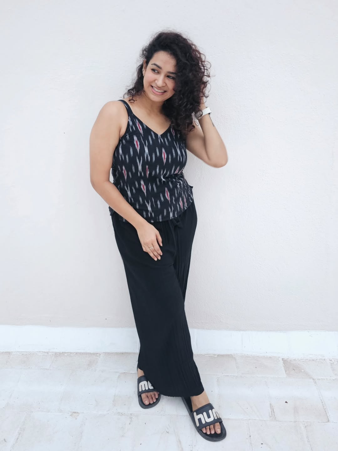 Meesha Ghoshal proves that effortless chic with a splash of humor is her signature style–rocking comfy black and a smile that’s brighter than her slides!