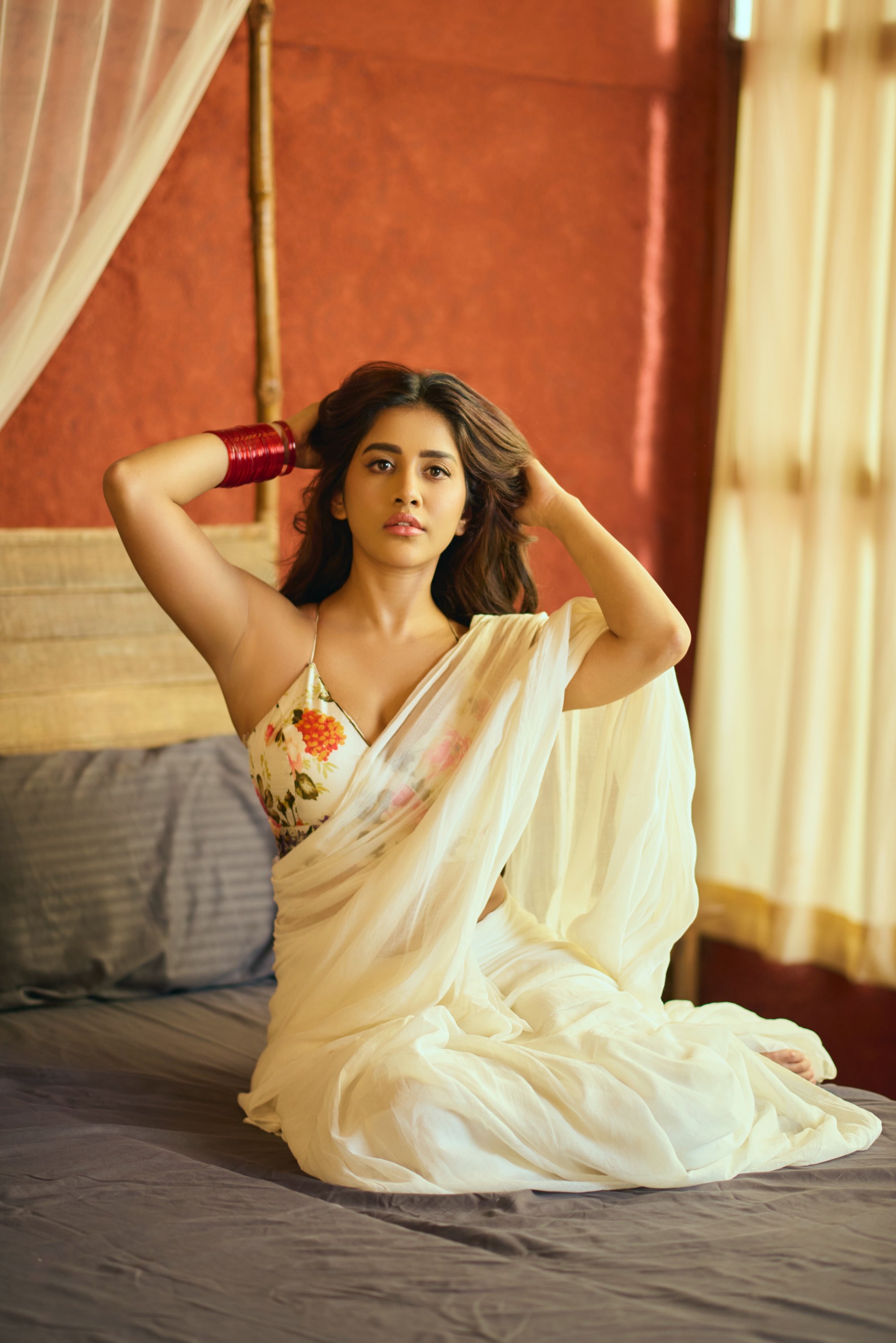 Nabha Natesh proves that timeless elegance and vibrant charm can coexist–wearing tradition like a crown, with a splash of bold red bangles to keep things interesting!
